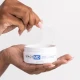 Hands using tweezers to take an eye mask out of the jar Hands using tweezers to take an eye mask out of the jar