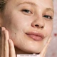 Model Cleansing face with Sculpted by Aimee Connolly DuoCleanse Exfoliating Cleanser Model Cleansing face with Sculpted by Aimee Connolly DuoCleanse Exfoliating Cleanser